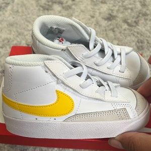 blazers. 8c. Brown Nike sign on the inside, yellow Nike sign on the outside.